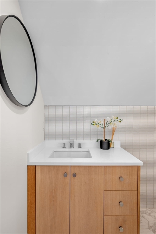 134 Elm Street, Unit 134 Marblehead, MA 01945 - Photo 29 of 38 a bathroom with a sink and a mirror