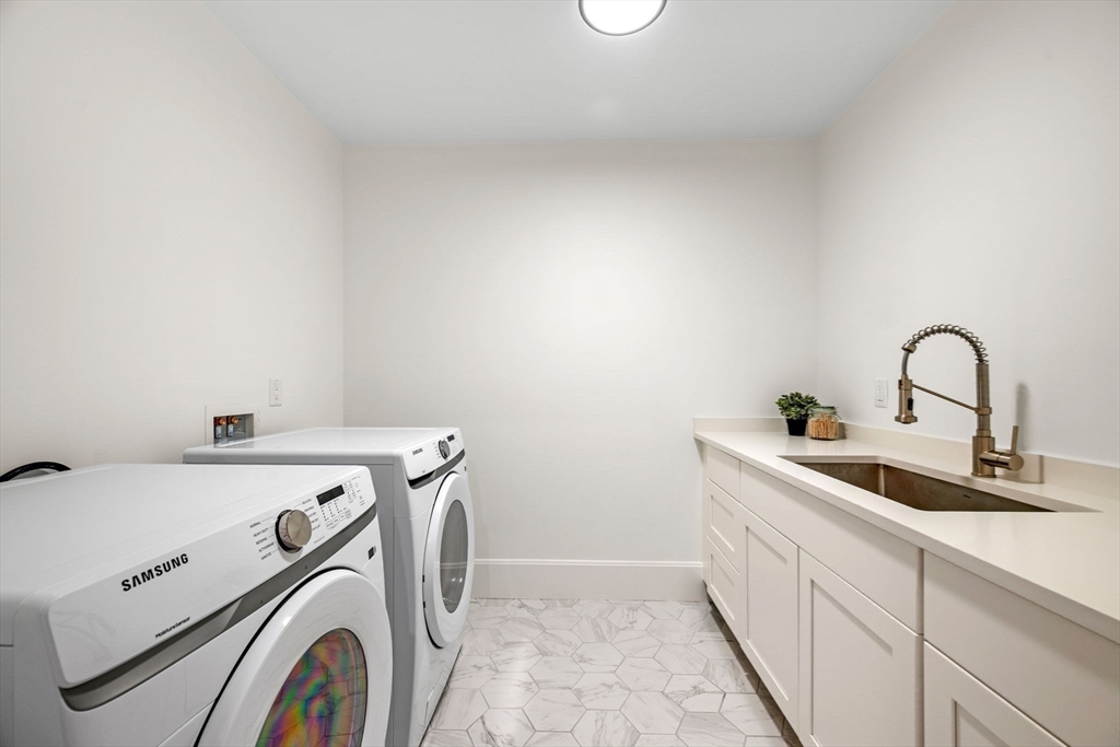 134 Elm Street, Unit 134 Marblehead, MA 01945 - Photo 30 of 38 a utility room with dryer and washer