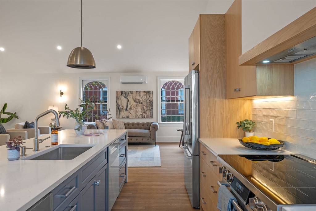 134 Elm Street, Unit 134 Marblehead, MA 01945 - Photo 6 of 38 a kitchen with sink stove and cabinets