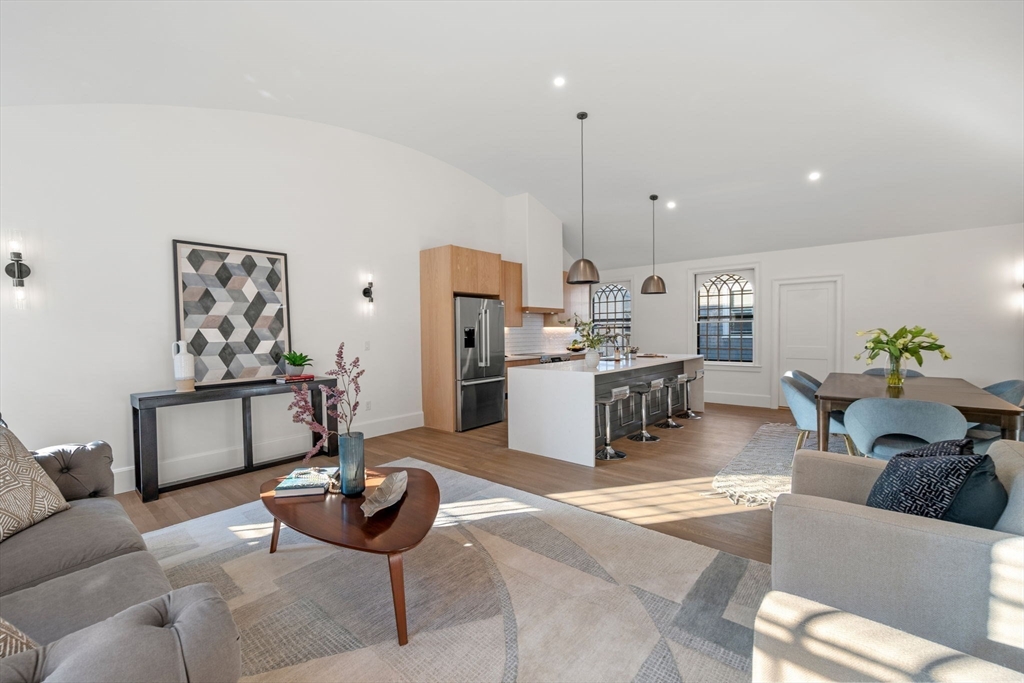 134 Elm Street, Unit 134 Marblehead, MA 01945 - Photo 7 of 38 a living room with furniture and kitchen view