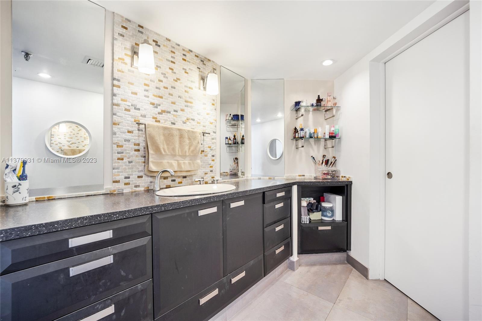 520 Brickell Key Drive, Unit APH10 Miami, FL 33131 - Photo 17 of 23 a spacious bathroom with a double vanity sink and a mirror