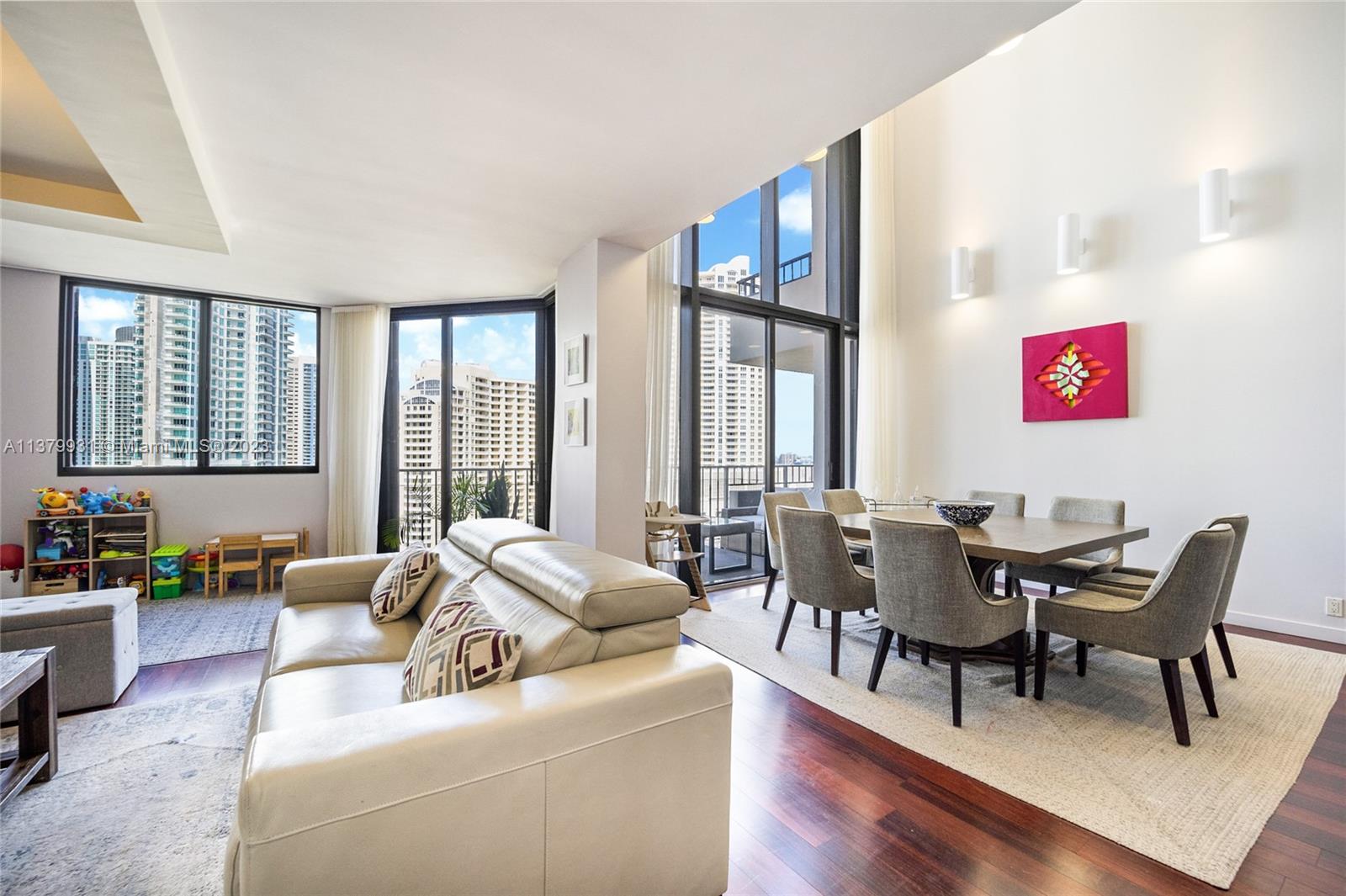 520 Brickell Key Drive, Unit APH10 Miami, FL 33131 - Photo 2 of 23 a living room with furniture and a large window