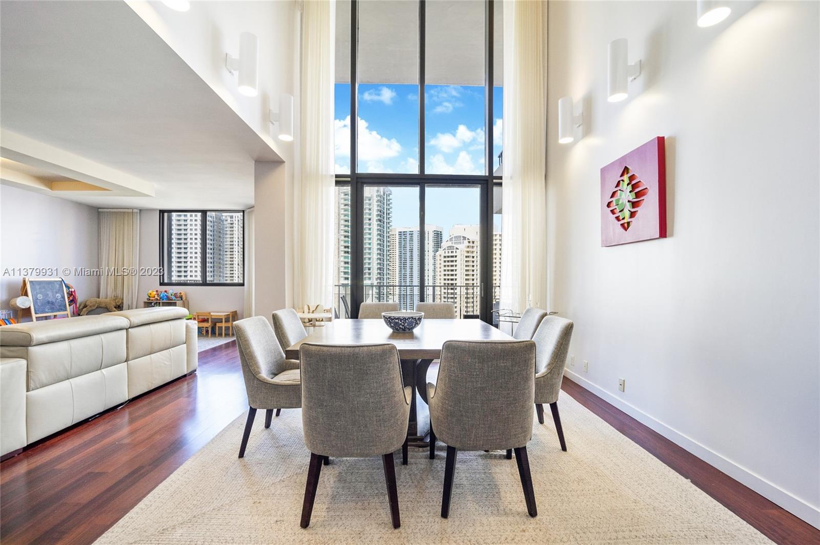 520 Brickell Key Drive, Unit APH10 Miami, FL 33131 - Photo 3 of 23 a view of a dining room with furniture window and wooden floor