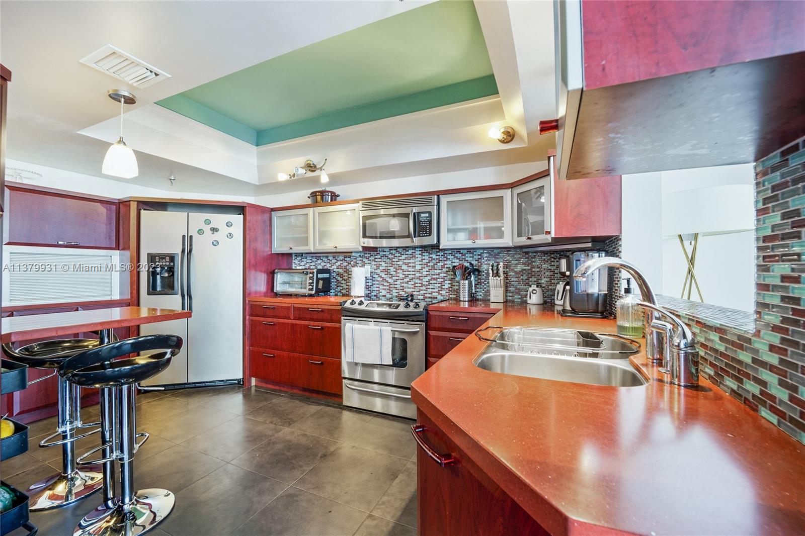 520 Brickell Key Drive, Unit APH10 Miami, FL 33131 - Photo 6 of 23 a kitchen with stainless steel appliances granite countertop a sink stove and refrigerator