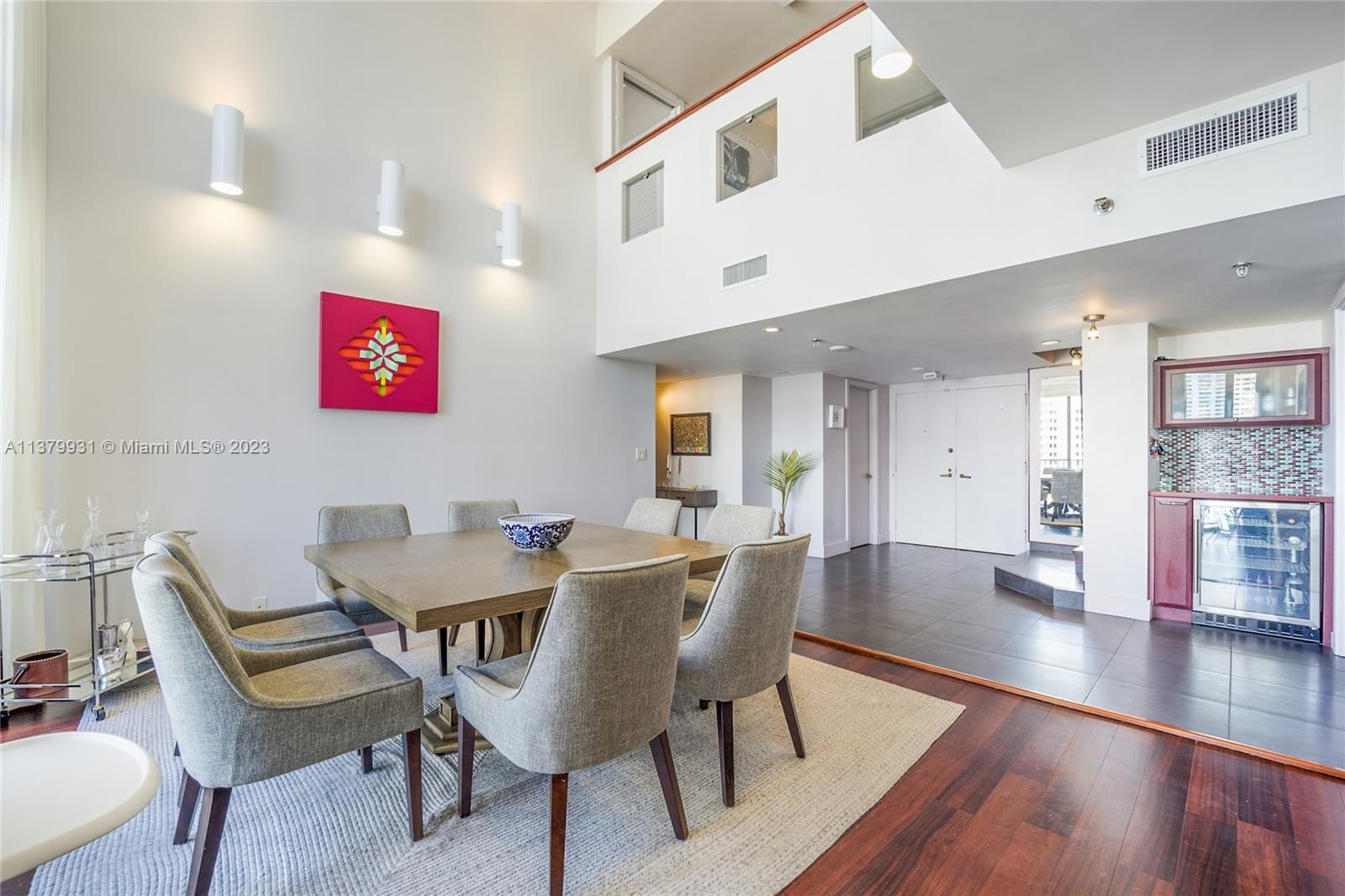 520 Brickell Key Drive, Unit APH10 Miami, FL 33131 - Photo 8 of 23 a view of a dining room with furniture and wooden floor