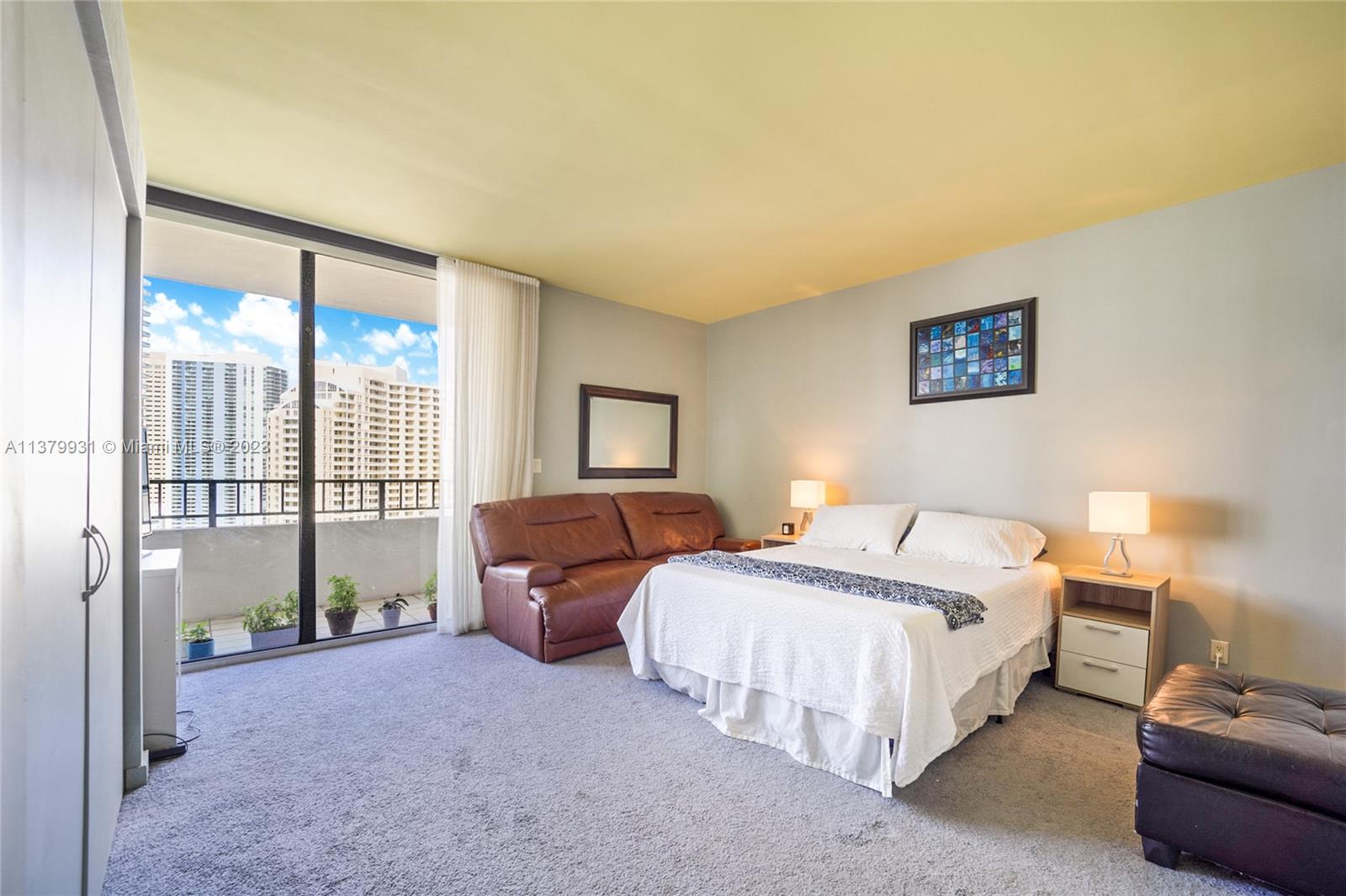 520 Brickell Key Drive, Unit APH10 Miami, FL 33131 - Photo 9 of 23 a bedroom with a bed and a night stand