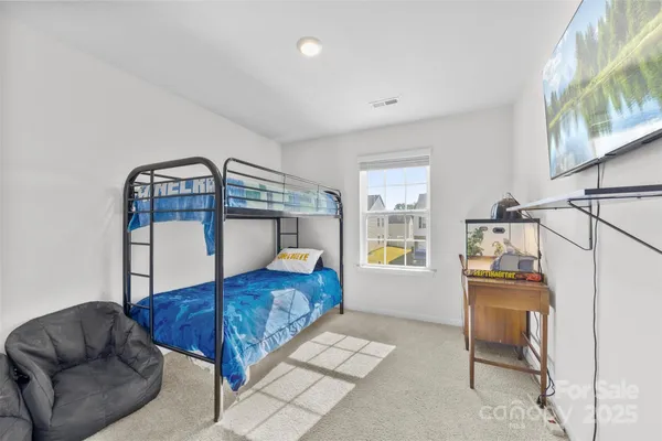 a bedroom with furniture and a window