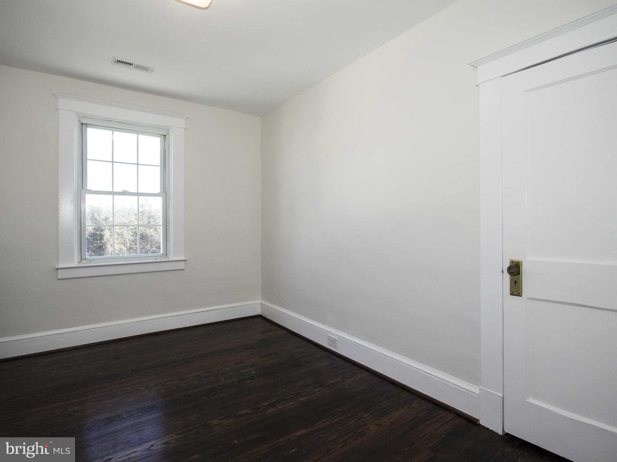 707 Elmwood Road Baltimore, MD 21206 - Photo 22 of 30 wooden floor in an empty room with a window