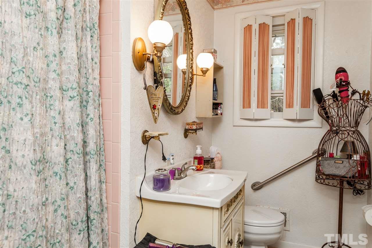 1421 Ashburton Road Raleigh, NC 27606 - Photo 14 of 24 a bathroom with a sink toilet and mirror