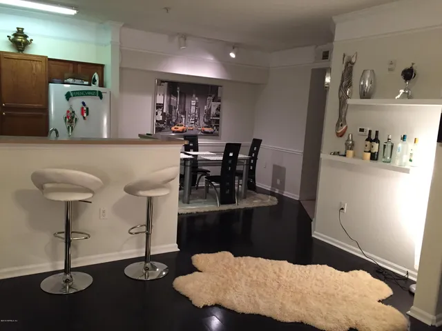 a living room with furniture and a dining table