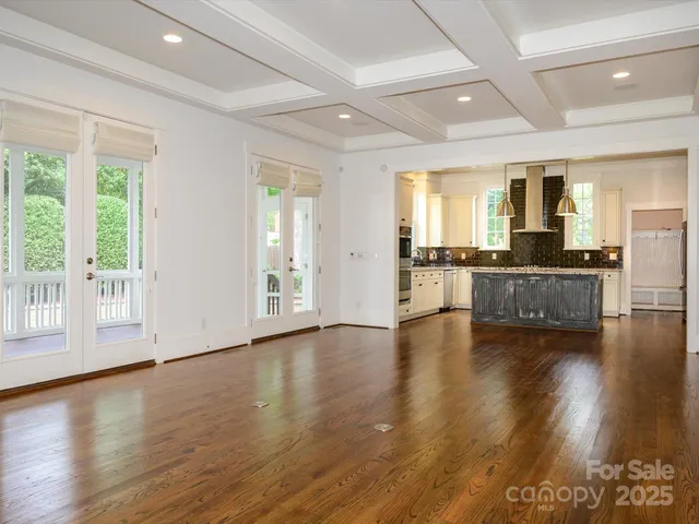 a view of a livingroom with furniture wooden floor and windows