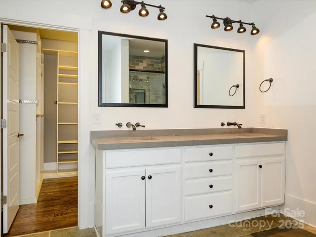 a bathroom with a sink vanity and mirror