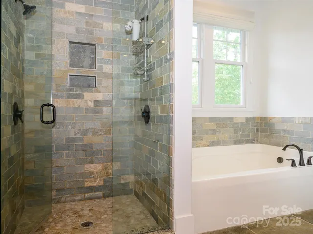 a bathroom with a bathtub and shower