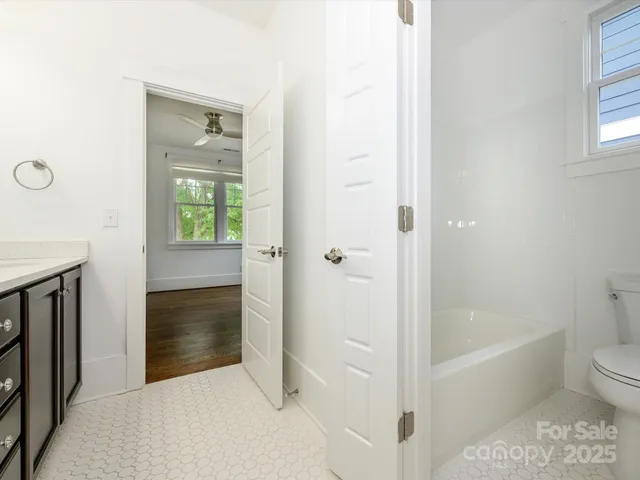 a bathroom with a tub shower and a sink