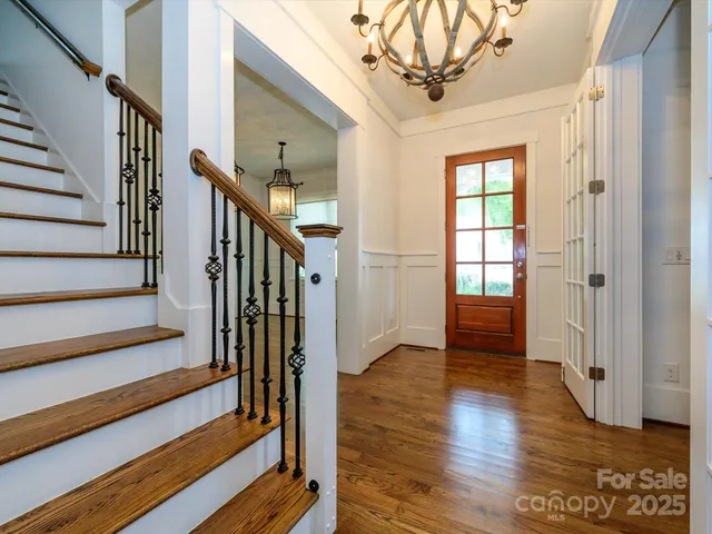 a view of an entryway with wooden floor and stairs
