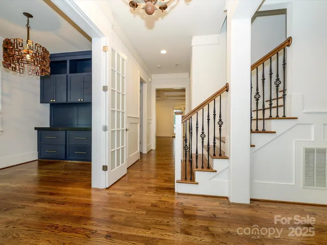 a view of entryway and hall with wooden floor