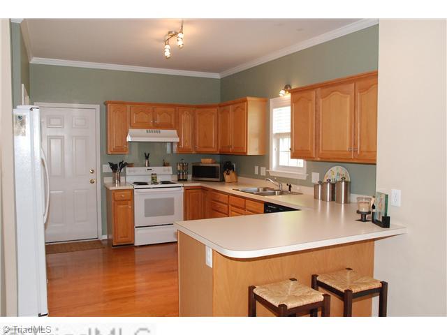 3707 Pointer Court High Point, NC 27265 - Photo 4 of 15 Kitchen. Hardwood flooring, neutral contertops and oak cabinets make the kitchen warm and inviting. You will love the expansive counters for food prep. The eating bar is perfect for snacks or a quick meal.