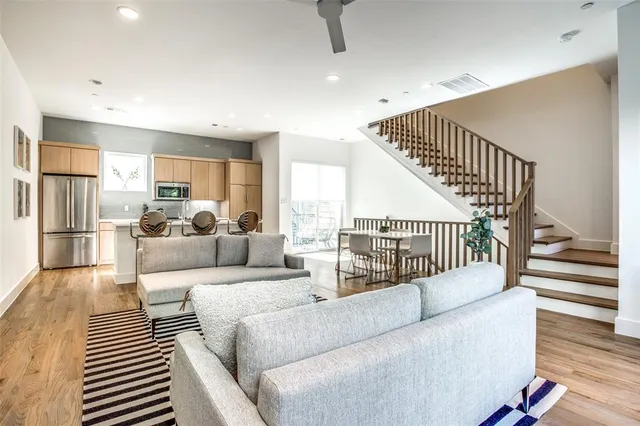 a living room with furniture or stairs and a wooden floor