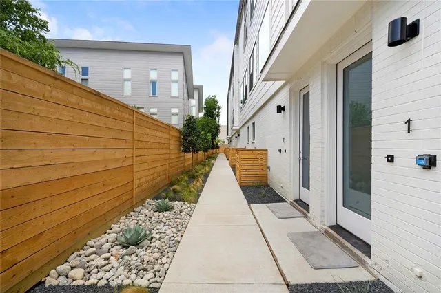 a view of a pathway along the house