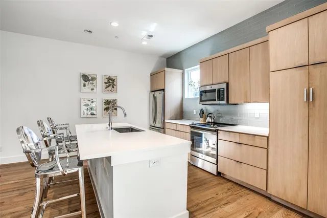 a kitchen with stainless steel appliances a refrigerator stove microwave and cabinets