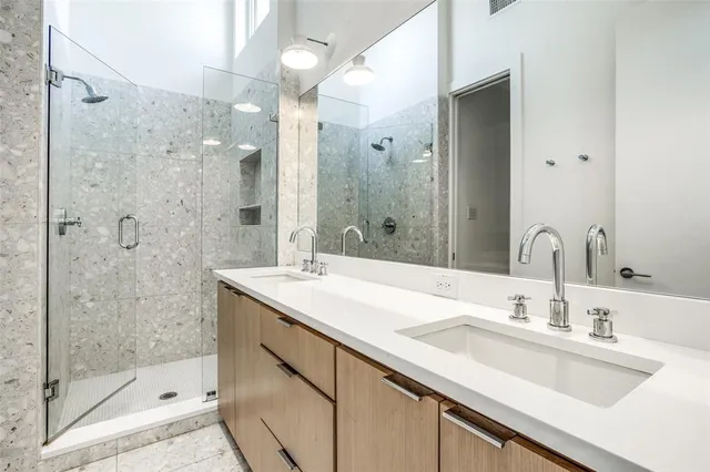 a bathroom with a sink shower and a mirror