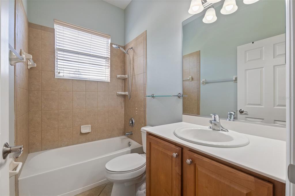 12150 Mapleridge Drive Parrish, FL 34219 - Photo 17 of 45 a bathroom with a sink toilet a mirror and shower