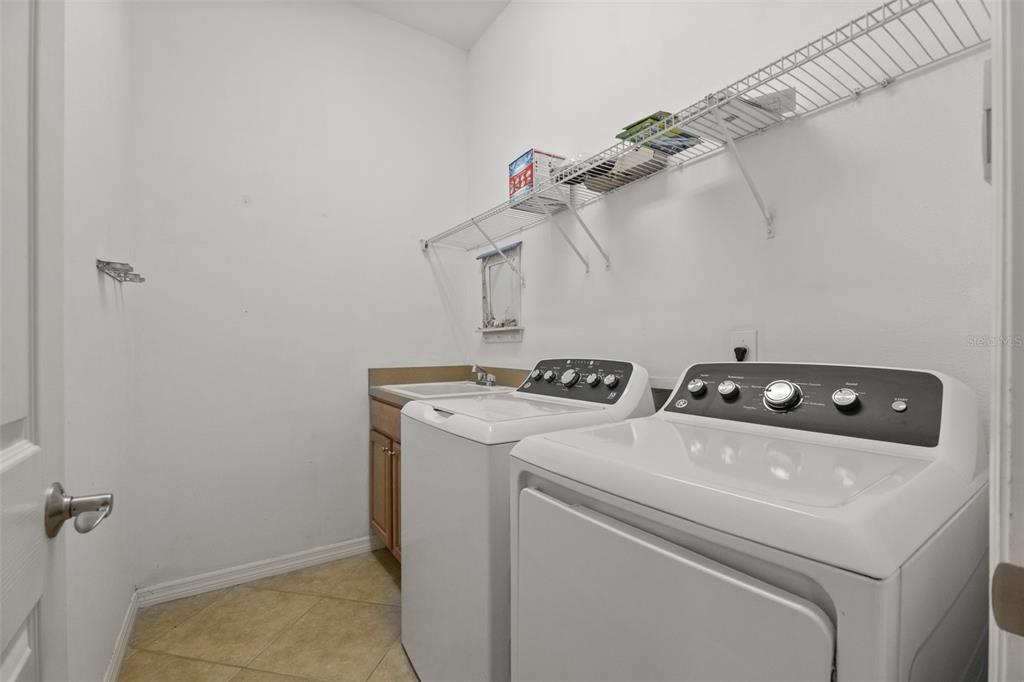 12150 Mapleridge Drive Parrish, FL 34219 - Photo 20 of 45 a utility room with dryer and washer