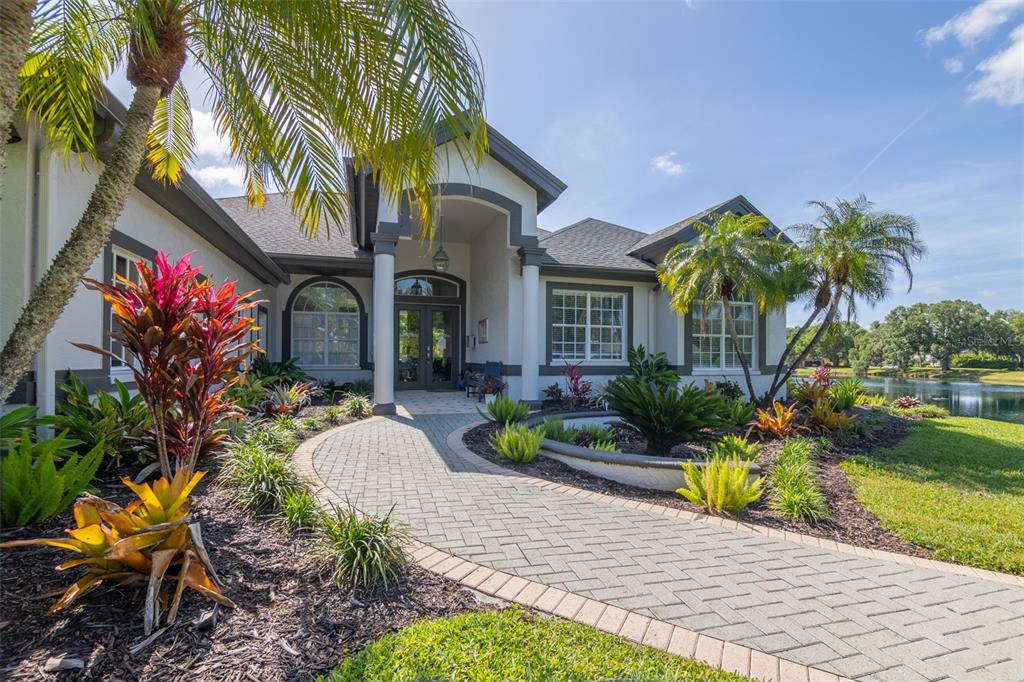 12150 Mapleridge Drive Parrish, FL 34219 - Photo 26 of 45 a front view of a house with a yard and potted plants