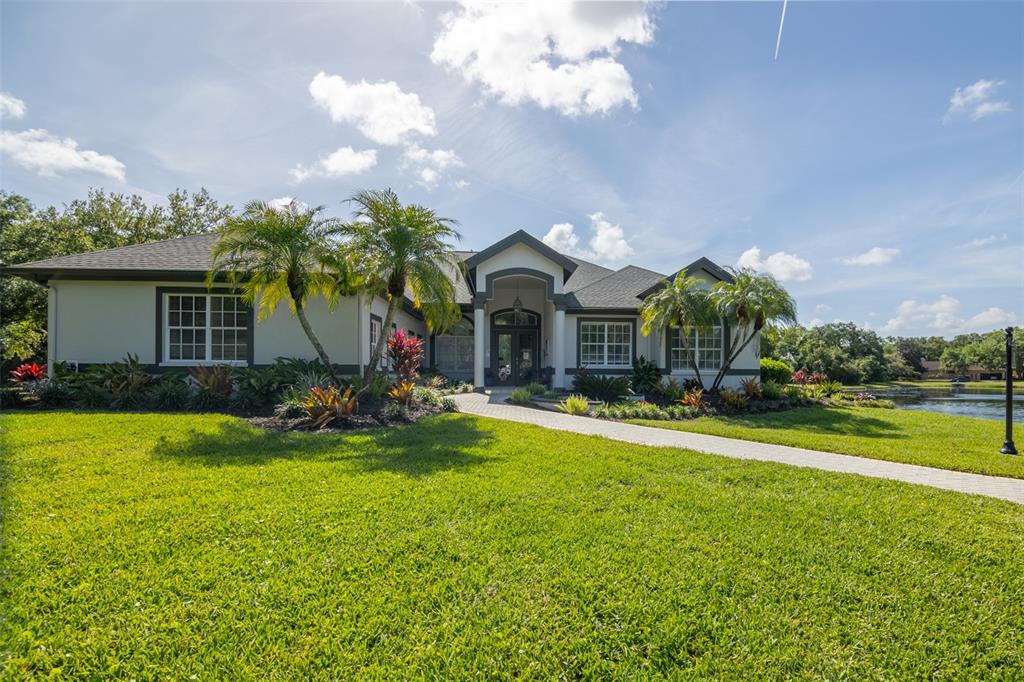 12150 Mapleridge Drive Parrish, FL 34219 - Photo 27 of 45 a view of a house with a swimming pool and a yard