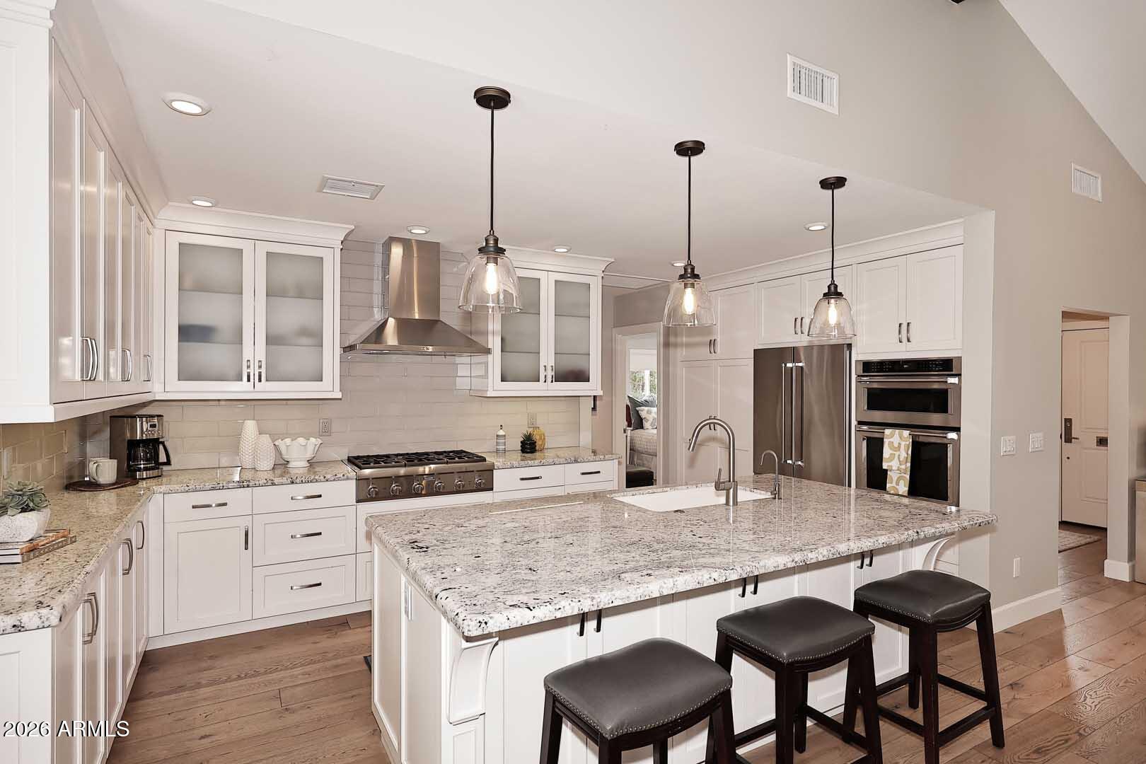 2525 East Pierson Street Phoenix, AZ 85016 - Photo 12 of 36 a kitchen with stainless steel appliances kitchen island granite countertop a sink and cabinets