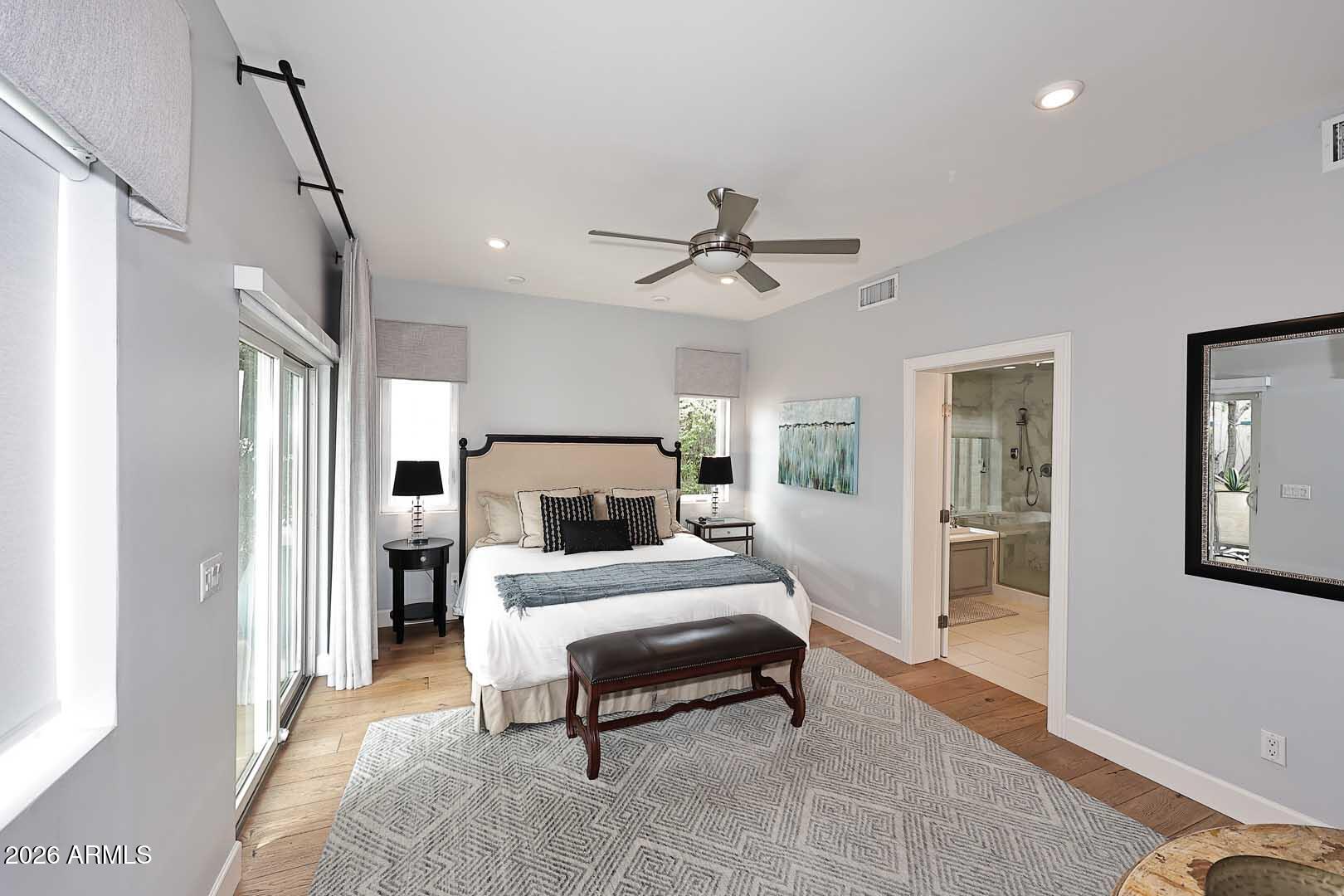 2525 East Pierson Street Phoenix, AZ 85016 - Photo 24 of 36 a spacious bedroom with a bed and a chandelier