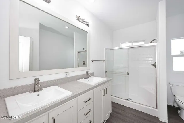 a bathroom with a sink double vanity and a mirror