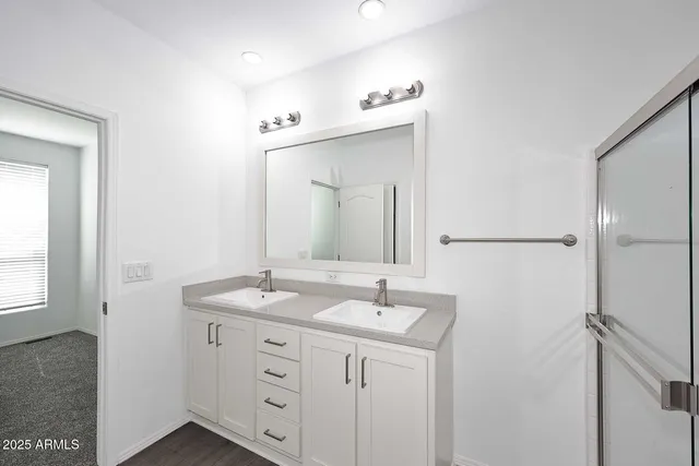 a bathroom with a sink vanity granite and a mirror