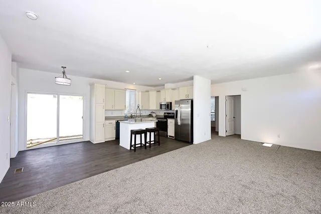 a view of kitchen with furniture and refrigerator