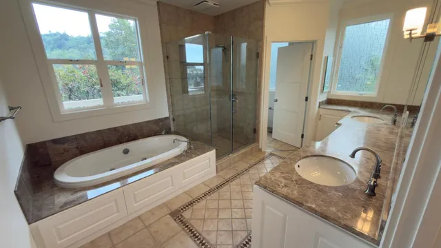a bathroom with double vanity sinks and a mirror