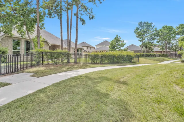 a view of green field with house in background