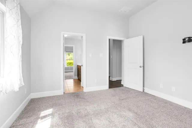 an empty room with windows and closet