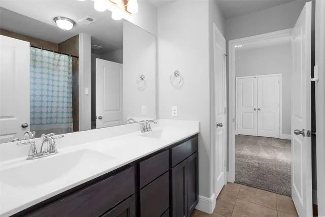 a bathroom with a sink double vanity and a mirror