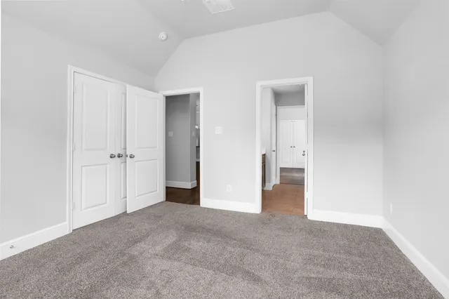 an empty room with closet and wooden door