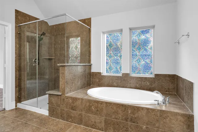 a bathroom with a granite countertop bathtub shower and sink