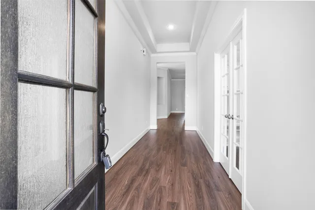 a view of a hallway with wooden floor