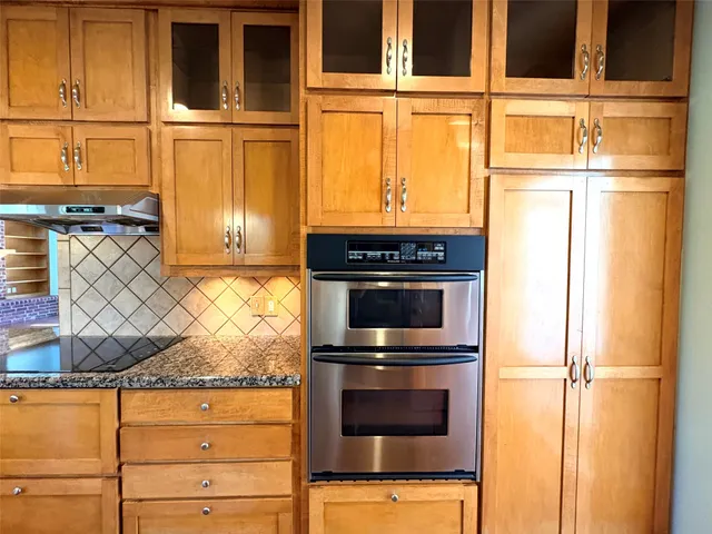a view of a room with chandelier and wooden floor