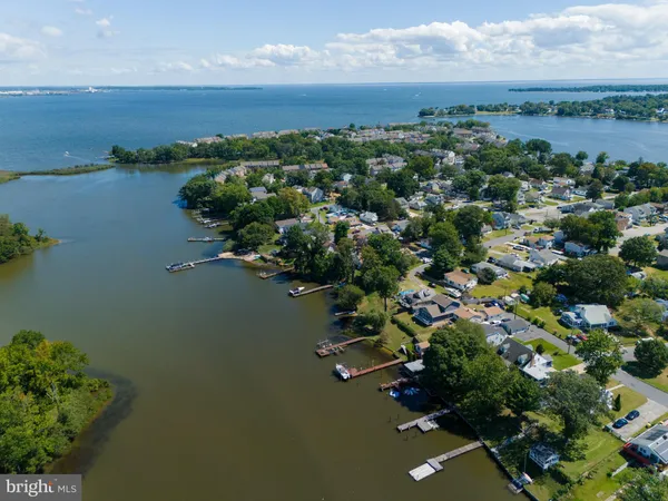 an aerial view of house with yard and lake view
