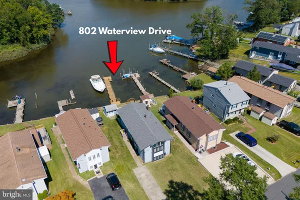a aerial view of a house with swimming pool and a yard