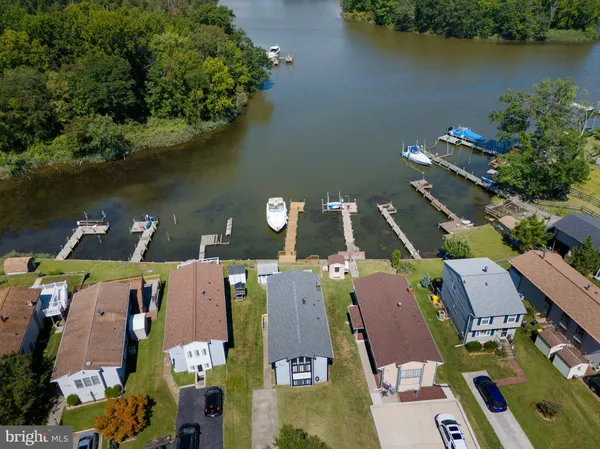 an aerial view of residential houses with outdoor space and street view