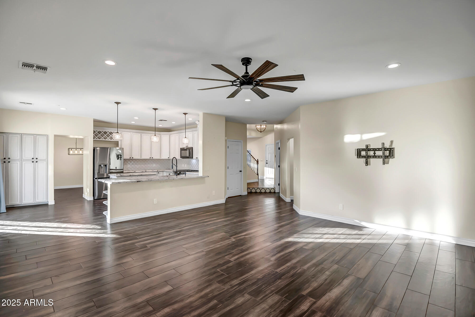 9569 West Redbird Road Peoria, AZ 85383 - Photo 11 of 36 a view of a kitchen with wooden floor and a kitchen