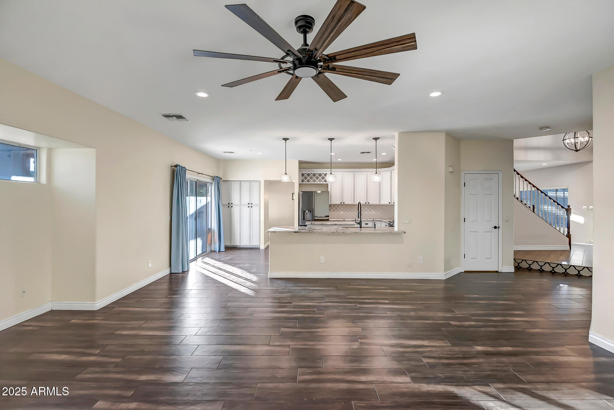 9569 West Redbird Road Peoria, AZ 85383 - Photo 12 of 36 a view of an empty room with window and wooden floor