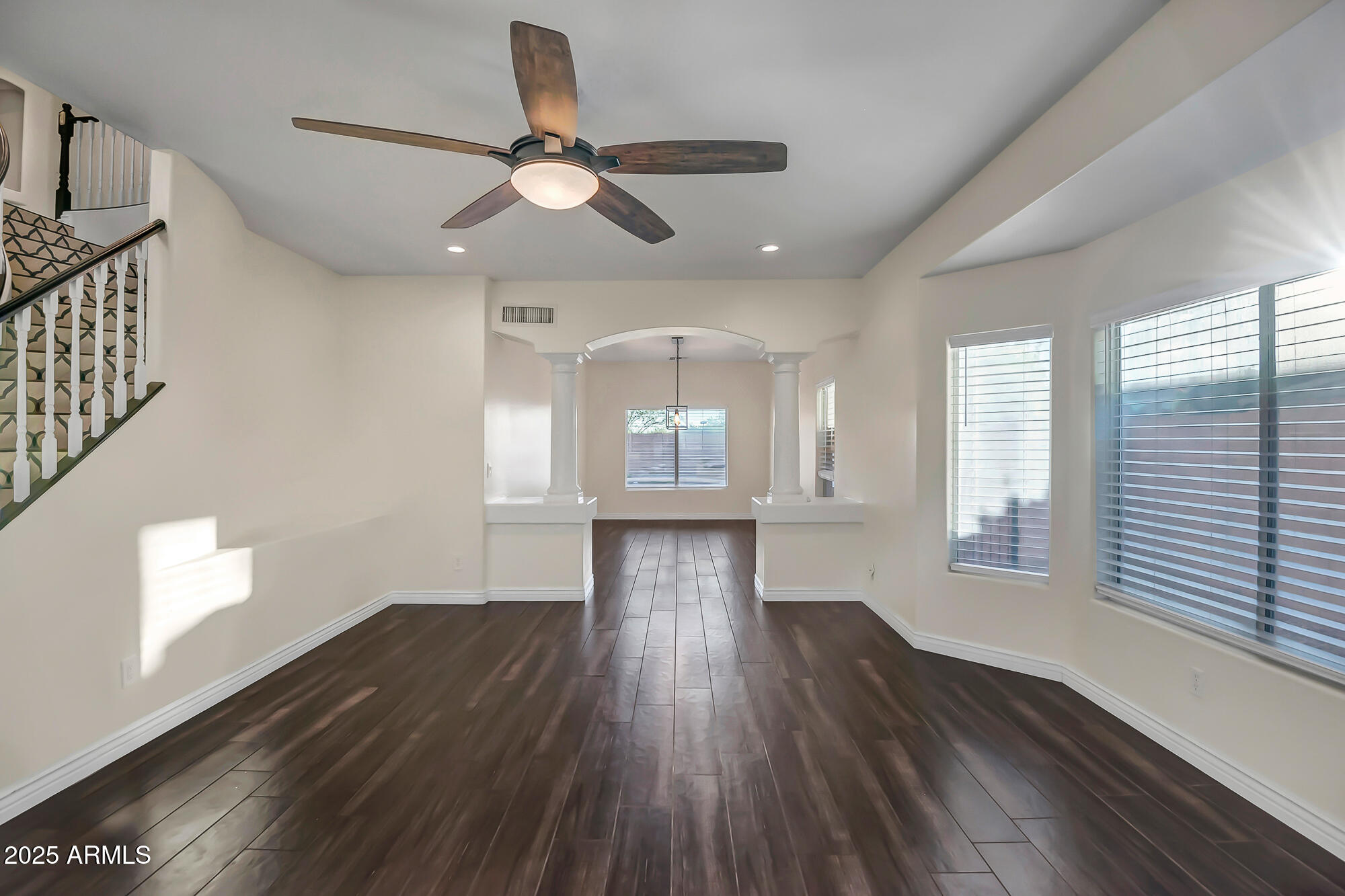 9569 West Redbird Road Peoria, AZ 85383 - Photo 14 of 36 a view of an empty room with wooden floor and a window