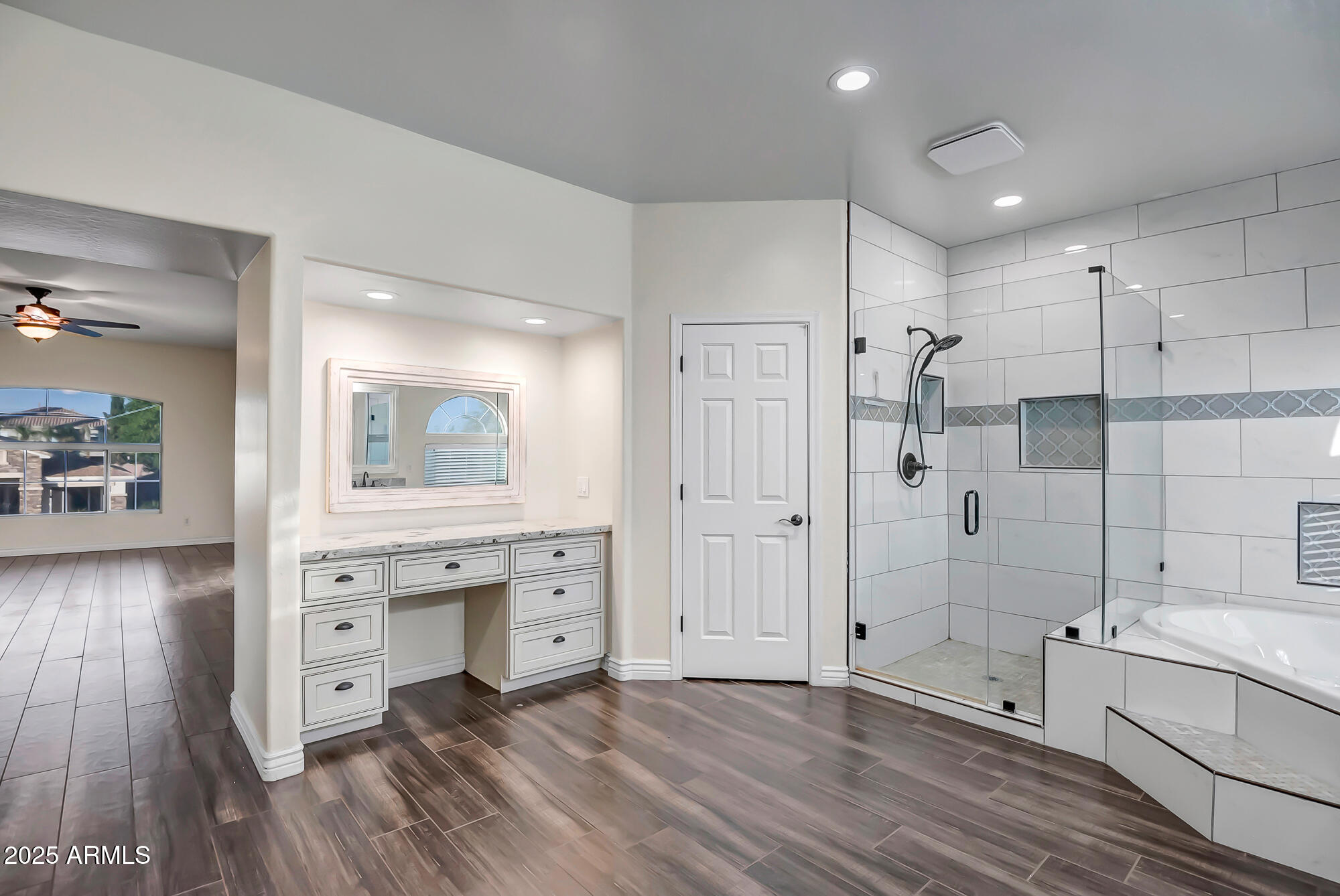 9569 West Redbird Road Peoria, AZ 85383 - Photo 17 of 36 a spacious bathroom with a double vanity sink a mirror and a bathtub