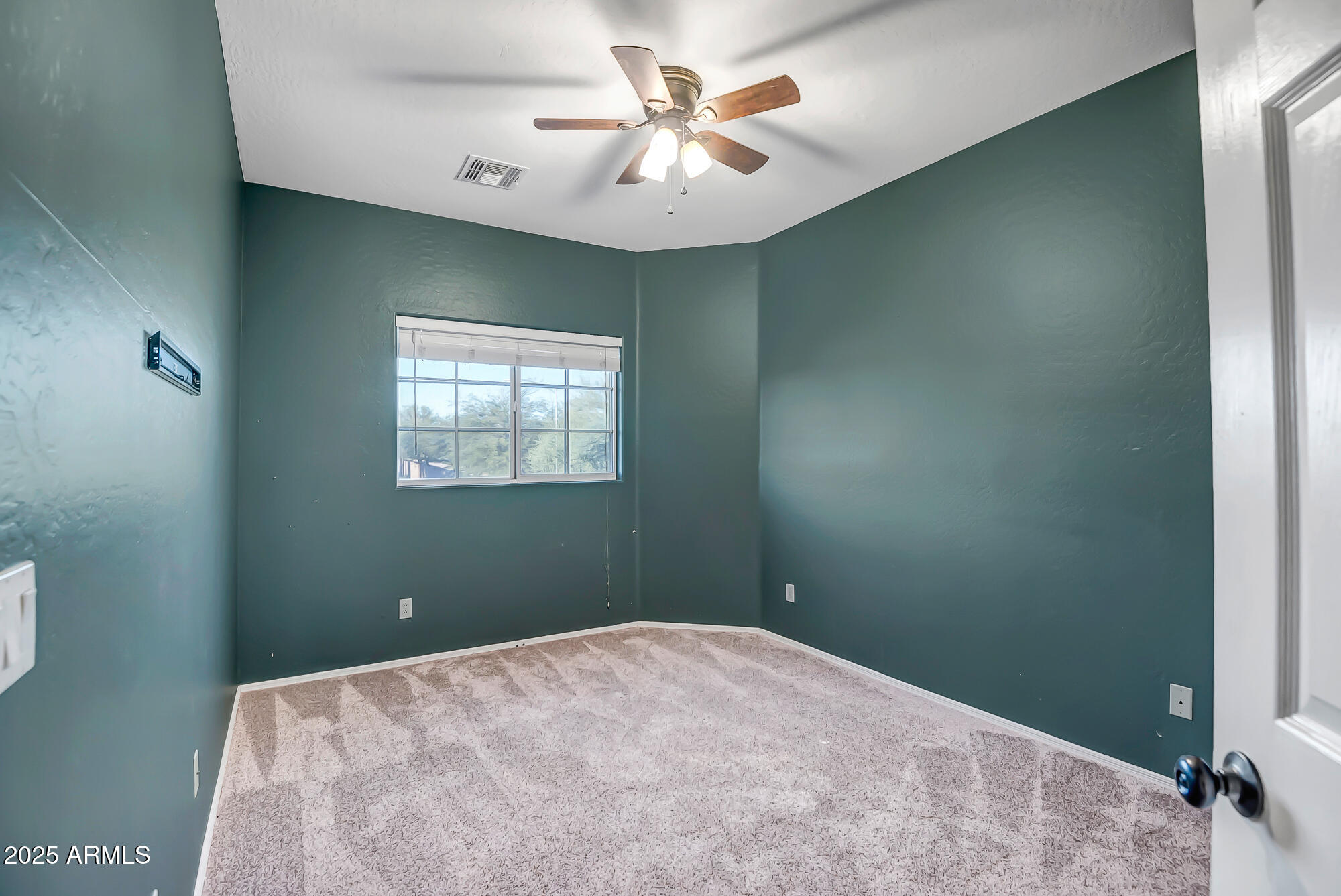 9569 West Redbird Road Peoria, AZ 85383 - Photo 22 of 36 a bedroom with a bed and a chandelier fan